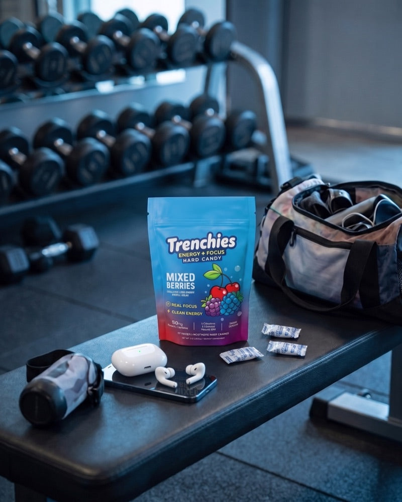 Trenchies pouch on a gym bench with dumbbells behind